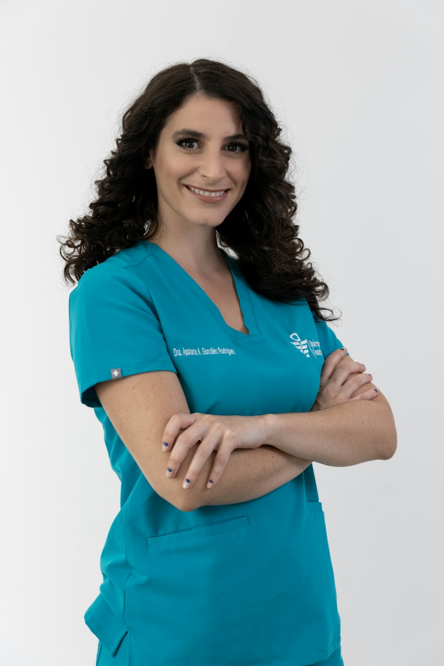 Stock portrait of a woman in blue scrubs, used as a fictional hygienist