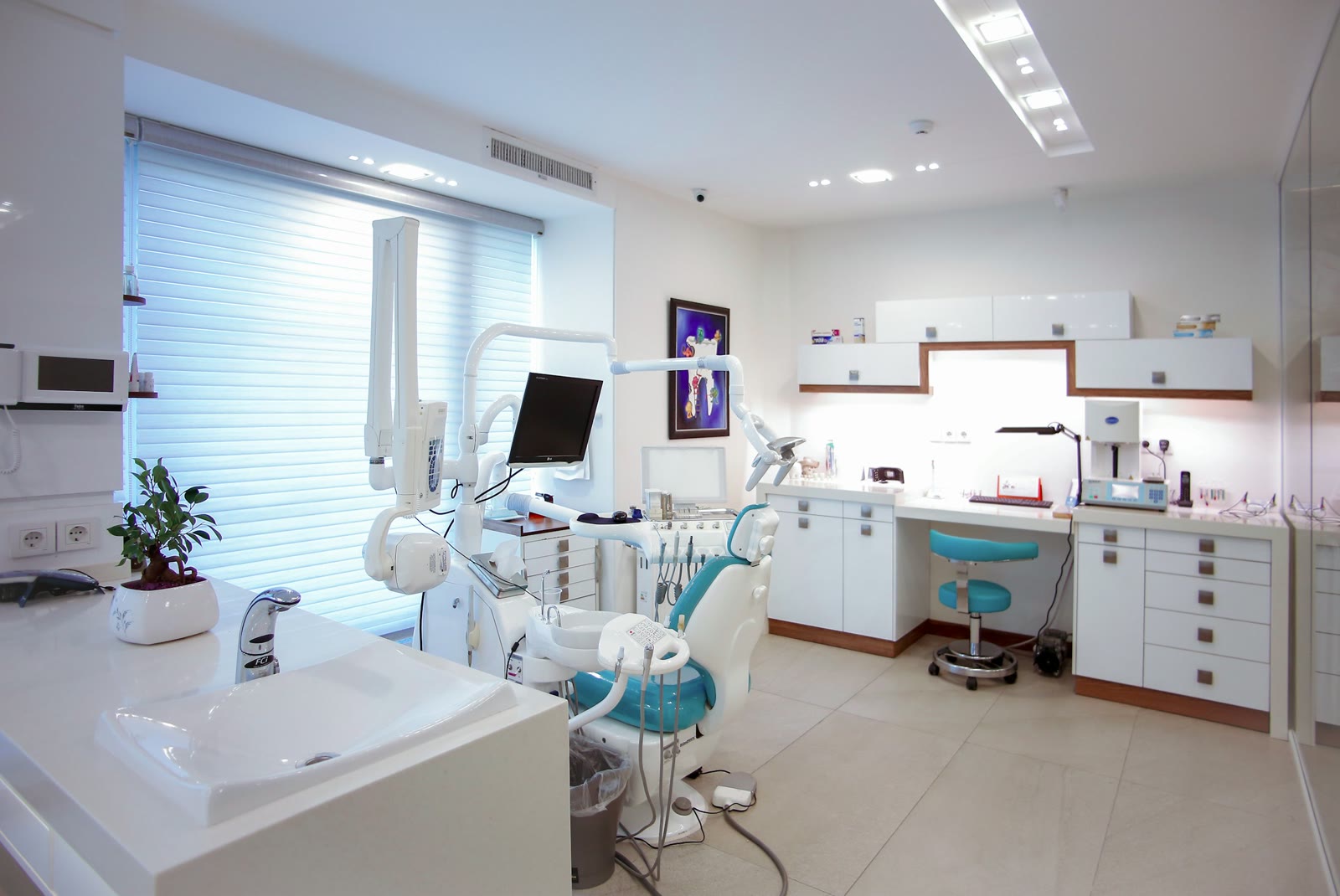 Bright dental treatment room with a chair and overhead light
