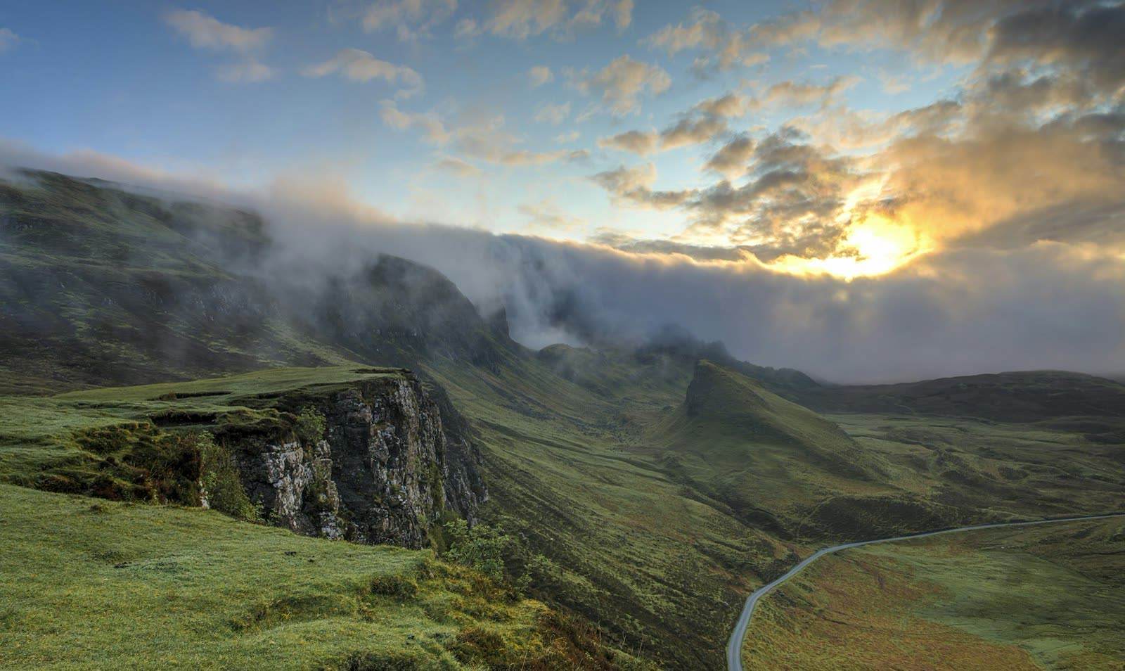 Fog over a green hillside